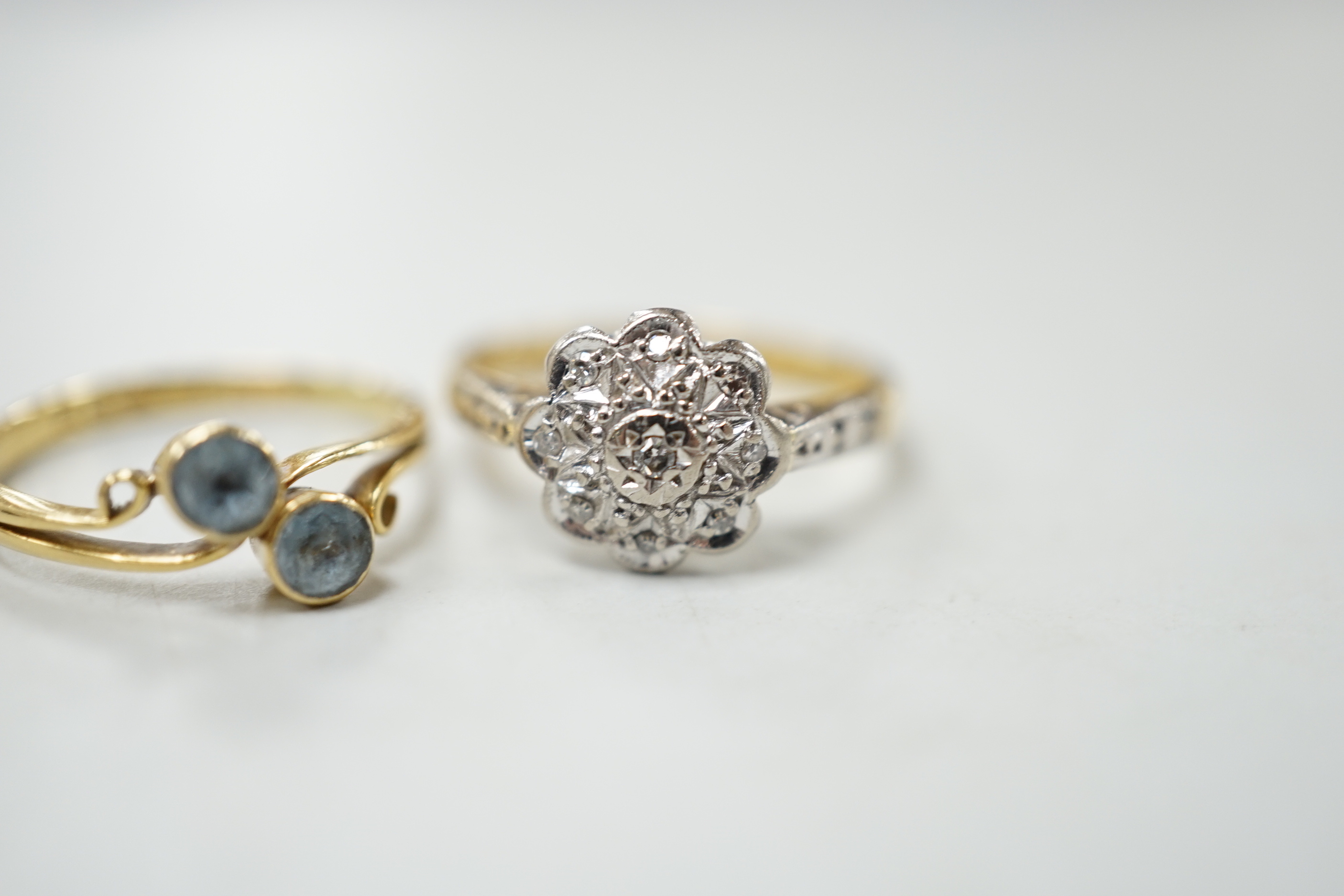 Two 18ct gold and gem set rings including illusion set diamond and blue stone crossover, gross weight 5.3 grams.